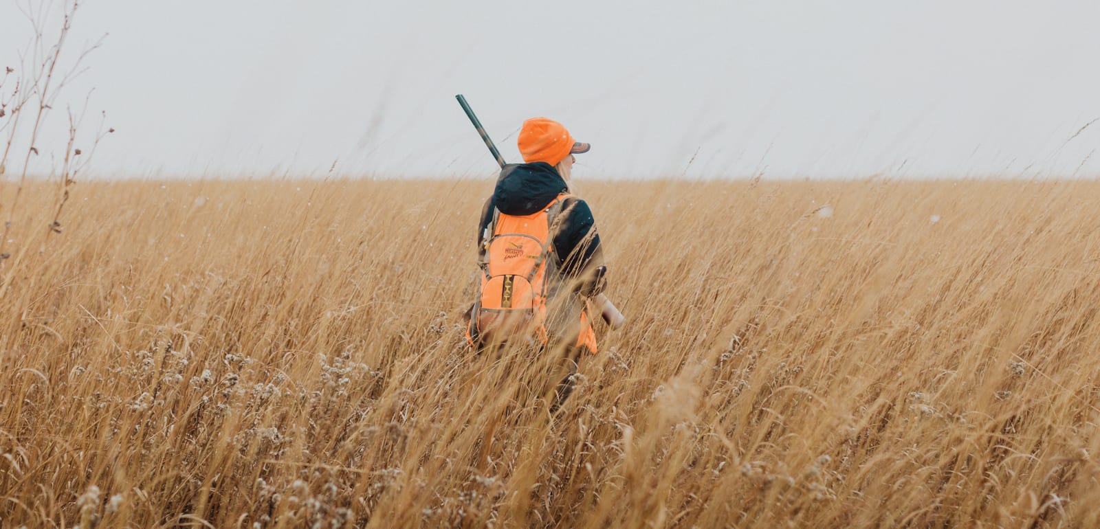 A first generation bird hunter in a field hunting for pheasant