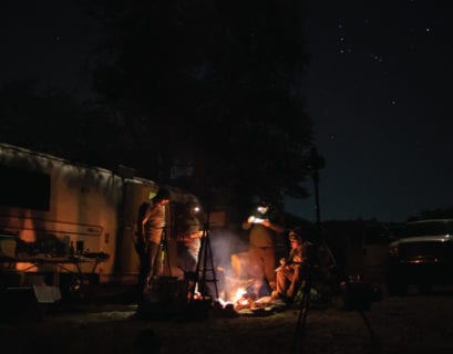 Bird hunters eating around a campfire